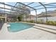 Refreshing pool area with screened enclosure and lush landscaping, creating a perfect backyard retreat at 10068 Chardonnay Dr, Orlando, FL 32832