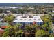 Aerial view of the condo building surrounded by lush landscaping and nearby amenities at 1150 Carmel Cir # 503, Casselberry, FL 32707