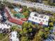 Aerial view of the community, with the building, pool, tennis court, and parking at 1150 Carmel Cir # 503, Casselberry, FL 32707