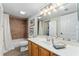 Well-lit bathroom features a single sink vanity and a shower-tub combination with brown tile surround at 1150 Carmel Cir # 503, Casselberry, FL 32707