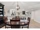 Open dining area showcasing dark wood table set with seating, and views to kitchen at 1150 Carmel Cir # 503, Casselberry, FL 32707