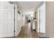 Hallway with white walls and wood-look tile floors leading to a sunlit living room at 1150 Carmel Cir # 503, Casselberry, FL 32707