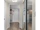 Hallway showcasing a bathroom and closet, creating functional connectivity between spaces at 1150 Carmel Cir # 503, Casselberry, FL 32707