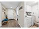 Hallway featuring a blue accent bench, laundry room, and front door at 1150 Carmel Cir # 503, Casselberry, FL 32707