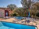 Community hot tub next to the pool area, surrounded by tables and shade trees at 1150 Carmel Cir # 503, Casselberry, FL 32707