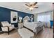 The main bedroom features a ceiling fan, an accent wall, and plenty of natural light at 1150 Carmel Cir # 503, Casselberry, FL 32707