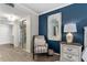 Tastefully decorated bedroom shows an accent chair, a full length mirror, and a neutral color palette at 1150 Carmel Cir # 503, Casselberry, FL 32707