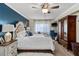 Comfortable main bedroom with a tufted headboard, ceiling fan, and traditional wooden furniture at 1150 Carmel Cir # 503, Casselberry, FL 32707