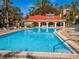 Large community pool with adjacent clubhouse featuring a spacious sun deck at 1150 Carmel Cir # 503, Casselberry, FL 32707