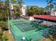 Well-maintained community tennis court with green surface and surrounding trees at 1150 Carmel Cir # 503, Casselberry, FL 32707