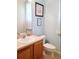 Bathroom featuring a vanity with storage, framed artwork, and soft blue walls at 1217 Cypress Pointe Blvd, Davenport, FL 33896