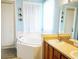 Bathroom with a large soaking tub, dual vanity with wooden cabinets, and ample natural light through window at 1217 Cypress Pointe Blvd, Davenport, FL 33896