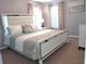 An elegant bedroom featuring a stylish white bed frame and a soft, patterned comforter set at 1217 Cypress Pointe Blvd, Davenport, FL 33896