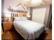 A bedroom showcasing a king bed and a cartoon wall art, offering a fun and inviting space at 1217 Cypress Pointe Blvd, Davenport, FL 33896