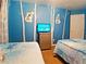 Cozy bedroom with twin beds and a whimsical themed decor at 1217 Cypress Pointe Blvd, Davenport, FL 33896