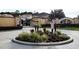 A landscaped community entrance welcomes you with lush greenery, decorative stones, and a stylish sign at 1217 Cypress Pointe Blvd, Davenport, FL 33896