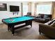 An entertainment room equipped with a pool table and comfortable seating, perfect for leisure and gatherings at 1217 Cypress Pointe Blvd, Davenport, FL 33896