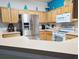 Spacious kitchen featuring light wood cabinets, stainless steel refrigerator, and white appliances at 1217 Cypress Pointe Blvd, Davenport, FL 33896