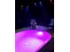 Outdoor swimming pool with lounge chairs, and colorful lighting for night-time enjoyment at 1217 Cypress Pointe Blvd, Davenport, FL 33896