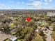 Expansive aerial view of a neighborhood with mature trees and blue skies on a sunny day at 130 Mandrake St, Orlando, FL 32811