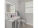 Well-lit bathroom with a modern vanity, framed mirror, and stylish fixtures at 130 Mandrake St, Orlando, FL 32811