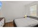 Clean bedroom with a large window for natural light, wood floors, and comfortable furniture at 130 Mandrake St, Orlando, FL 32811