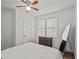 Sun-drenched bedroom featuring a ceiling fan, windows, and a dresser offering space and functionality at 130 Mandrake St, Orlando, FL 32811