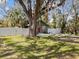 Quaint bungalow with an old oak tree, red door, and a white picket fence at 130 Mandrake St, Orlando, FL 32811