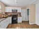 Bright kitchen features white cabinetry, stainless steel appliances, and a brick backsplash at 130 Mandrake St, Orlando, FL 32811