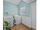 Bright laundry room with a washer, dryer, and plenty of space for storage with vinyl wood flooring at 130 Mandrake St, Orlando, FL 32811