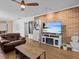Comfortable living room with laminate floors, brick accent wall, and modern decor at 130 Mandrake St, Orlando, FL 32811