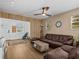 Cozy living room featuring laminate floors, a ceiling fan, and a decorative wood divider at 130 Mandrake St, Orlando, FL 32811