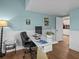 Inviting office featuring a desk area with a computer and view to the kitchen at 130 Mandrake St, Orlando, FL 32811