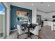 Chic dining area with a round table, stylish chairs, and an accent wall with modern art at 1327 Fan Palm Dr, Davenport, FL 33897