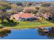 Overhead image of a home with an expansive backyard, private dock, and mature trees near a tranquil lake at 13509 Lake Luntz Dr, Winter Garden, FL 34787