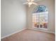 Bright carpeted bedroom featuring a unique arched window with natural light at 13509 Lake Luntz Dr, Winter Garden, FL 34787