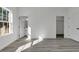 Bright bedroom with gray wood-look flooring, closet, and door to the en suite bathroom at 14480 Sw 68Th Ter, Ocala, FL 34473