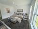 Serene main bedroom featuring soft lighting, neutral decor, an area rug, and large windows for natural light at 14480 Sw 68Th Ter, Ocala, FL 34473