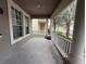 Inviting front porch with white railings and columns, offering a relaxing outdoor space at 14674 Black Cherry Trl, Winter Garden, FL 34787