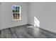 Cozy bedroom with luxury vinyl plank flooring, a bright window, and fresh white paint at 15657 Sw 37Th Cir, Ocala, FL 34473