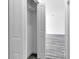 A bedroom closet with white wire shelving is shown from doorway with luxury vinyl floors in view at 15657 Sw 37Th Cir, Ocala, FL 34473