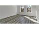 An airy bedroom featuring luxury vinyl plank flooring, natural light, and neutral walls at 15657 Sw 37Th Cir, Ocala, FL 34473