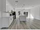 Modern kitchen featuring a center island, stainless steel appliances, and sleek gray flooring at 15657 Sw 37Th Cir, Ocala, FL 34473