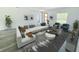 Bright living room featuring a large sectional sofa, sleek flooring, and contemporary decor with a view at 15657 Sw 37Th Cir, Ocala, FL 34473