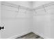 A large walk-in closet with modern wire shelving and luxury vinyl plank flooring is shown at 15657 Sw 37Th Cir, Ocala, FL 34473