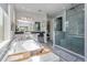 Bright bathroom with large tub, glass-enclosed shower, and double sink vanity at 15732 Shorebird Ln, Winter Garden, FL 34787