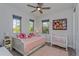 room with neutral decor and multiple windows with a daybed and a crib at 15732 Shorebird Ln, Winter Garden, FL 34787