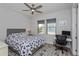 Bedroom featuring neutral walls, ceiling fan, and desk space near sunlit windows at 15732 Shorebird Ln, Winter Garden, FL 34787