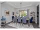 Elegant dining room with a coffered ceiling, a modern chandelier, and large windows for natural light at 15732 Shorebird Ln, Winter Garden, FL 34787
