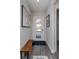 Inviting entryway with a white door that features glass panes, stylish wood floors, and modern artwork at 15732 Shorebird Ln, Winter Garden, FL 34787